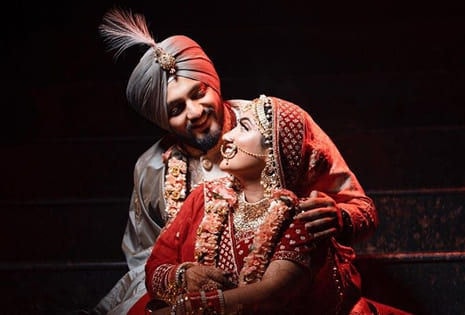Groom and bride holding hands on stairs